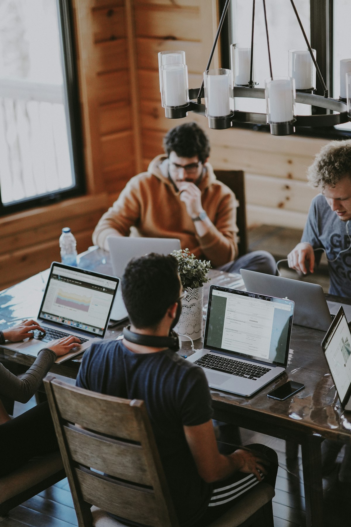 People sharing ideas around a table in a bright workspace